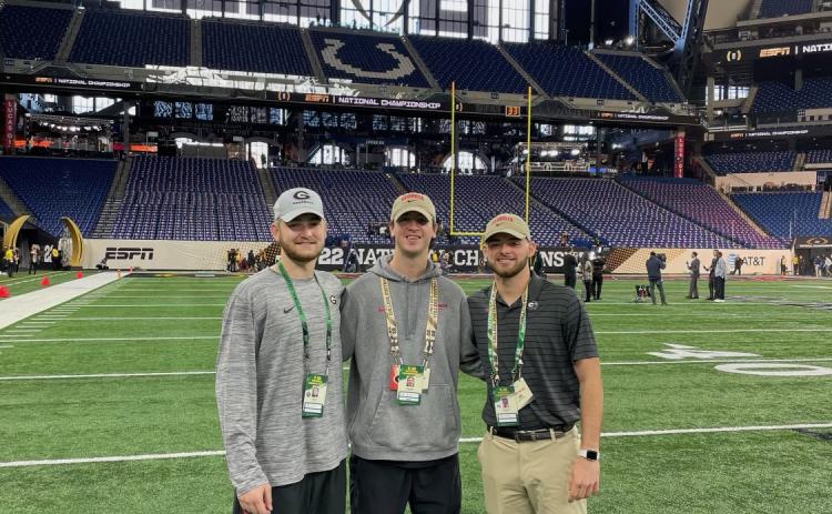 Former Hart County High Schoolers and Georgia football equipment managers (from left to right) Kirby King Carter Banks Preston Mewborn stand field level at Lucas Oil Stadium before Monday night’s national championship game.