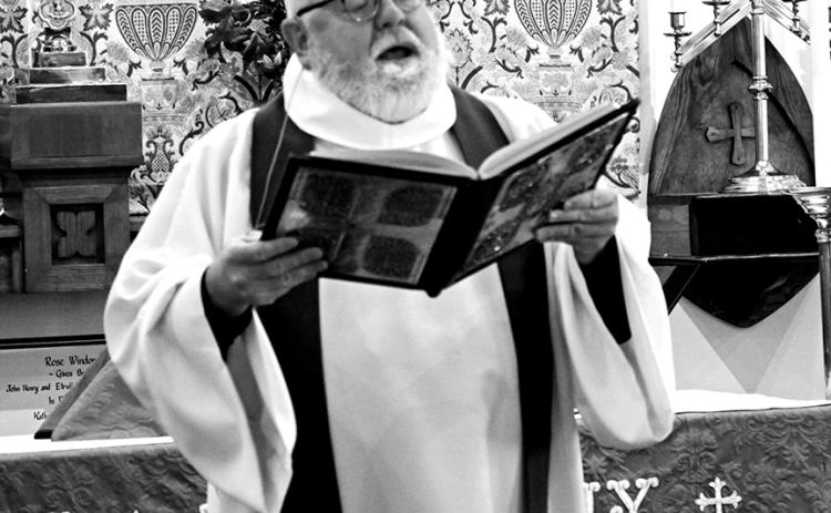 Hamilton leading his congregants in worship.