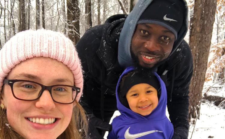 Kerv Augustin and his wife Rachel enjoy the snow with their daughter Eleanora Grace. Their youngest two, Margot and Killian, are not pictured.