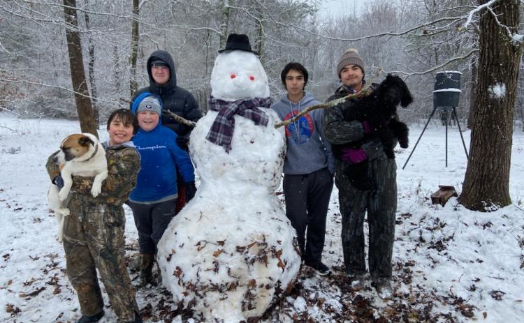 Kids in Hartwell enjoy a rare opportunity to get outside and build a snowman. Pictured from left to right, Tate Oglesby with dog Rocky, Brady Vickery, Blake Vickery, Tucker Oglesby and Payne Oglesby with dog Izzy.