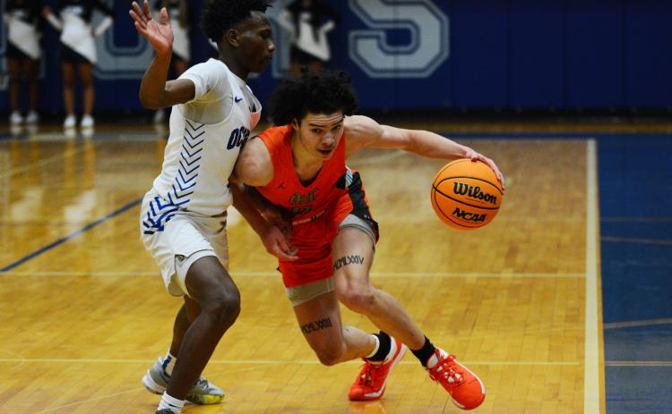 Johnny Curry draws the foul against the Oconee County defender on Tuesday, Jan. 24.