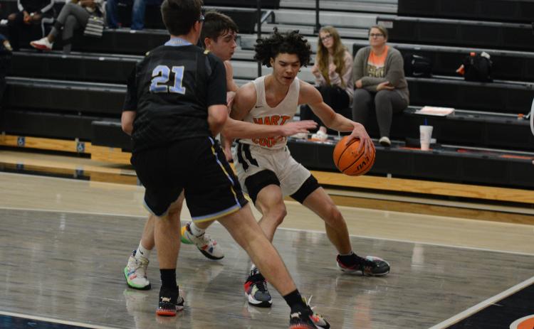 Johnny Curry fights through Daniel defenders along the baseline in the Dog’s loss on Wednesday, Dec. 29.