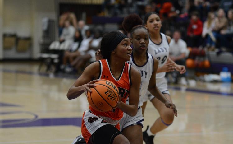 Valasha Carter drives into the paint against Monroe Area High School.