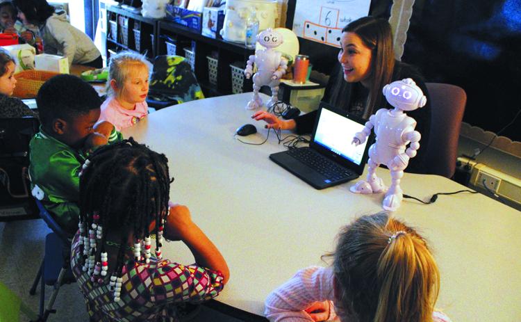 Kindergarten teacher, Mrs. Hannah Jones, sets up ABii to read aloud to a group of students.