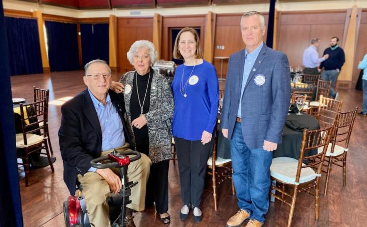 From left to right, Rotarian Joe Whittemore, Barbara Edmunds, Cathy Edmunds Redfern and Rotary president Rich Mewborn smile after celebrating a moment for their friend and family member Jack Edmunds.