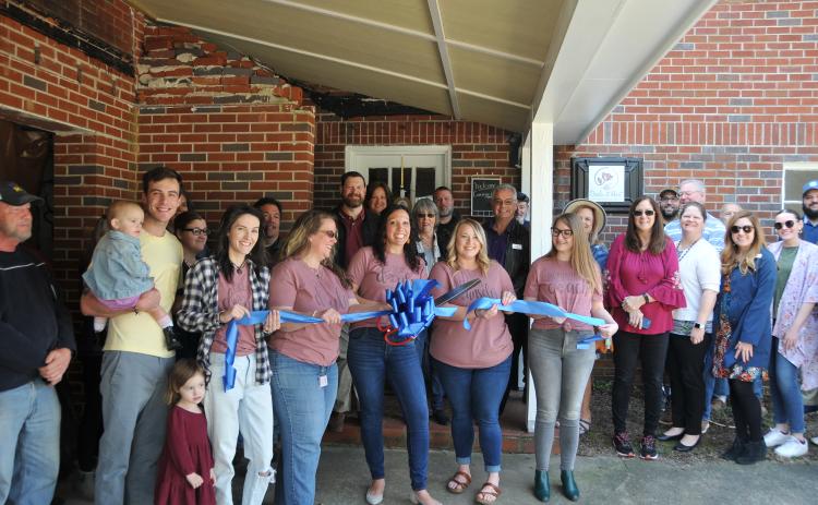 Megan McCurley joins a large Hartwell contingency and cuts the ribbon on the new Doula at Hart office at 236 W. Franklin Street.