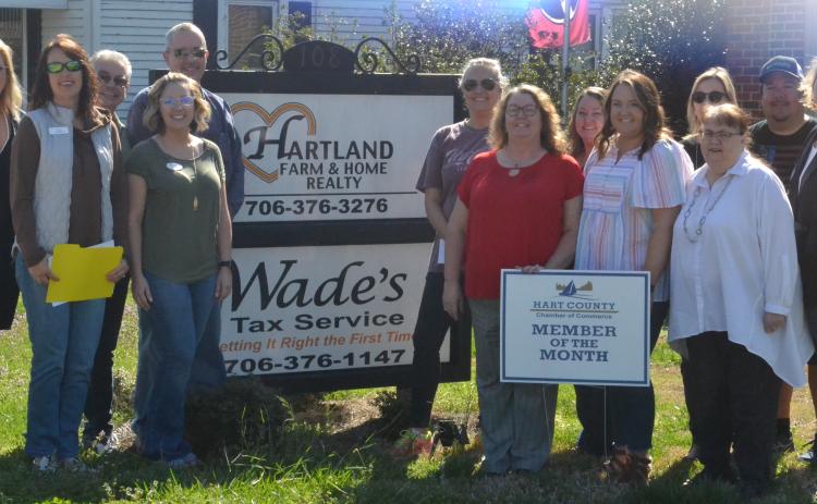 Pictured left, realtors and other Hartland employees join Chamber reps in front of the Hartland Realty office.