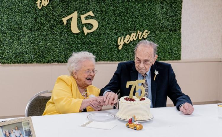 Jean and Albert Maxwell cut the cake together on Saturday in celebration of their 75th anniversary.