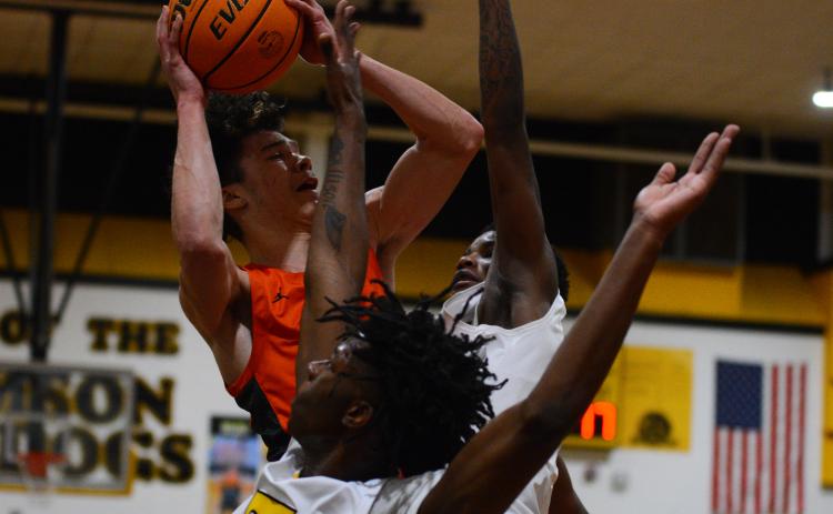 Johnny Curry takes a shot in traffic in his final high school game at Thomson High School on Saturday, Feb. 25.