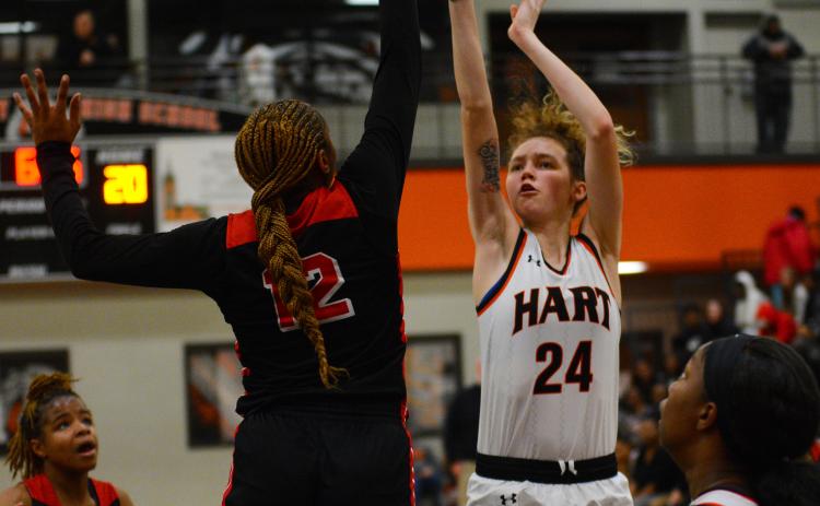 Abbygail McLane shoots over one of her opponents.