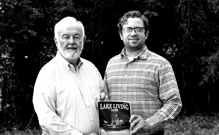 Award-winning photographer Bill Powell, left, stands alongside The Hartwell Sun publisher Dan Hunt and a print of his Lake Living cover shot.