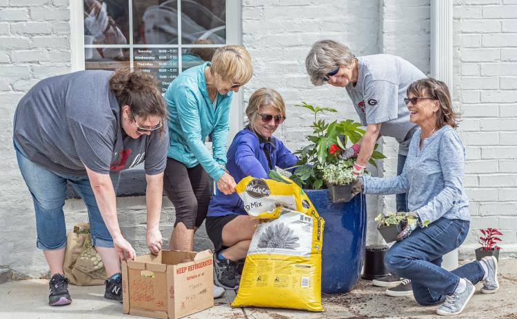 Main Street volunteers (L-R) Amanda Brown, Karen Vahaly, Chrissy Warren, Sandra Baker and Carol Beazley freshen up Depot Street.