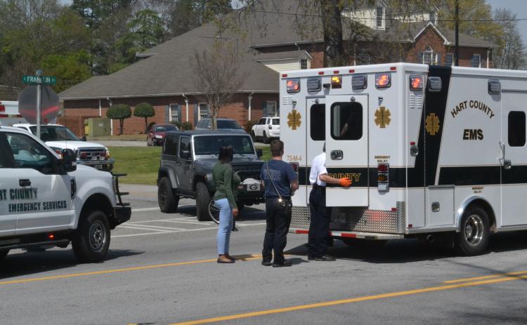 Hartwell EMS checks on a pedestrian in the back of ambulance who was allegedly struck by a car minutes earlier on Tuesday afternoon, April 12.
