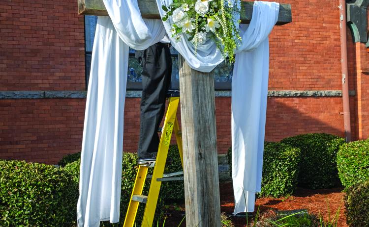 Bruce Herring puts the finishing touches on the cross at Hart First United Methodist Church.