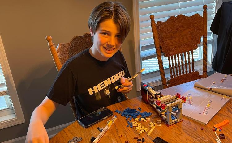 Jackson Ford lays out the pieces of his Titanic model in the initial phase.