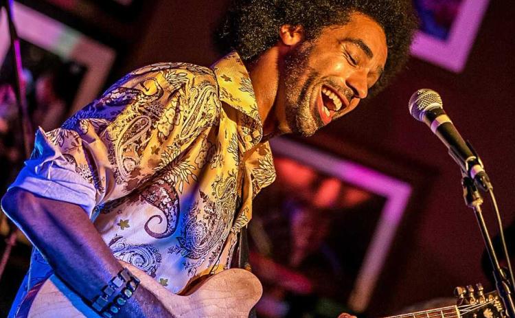 Selwyn Birchwood playing guitar during a set.