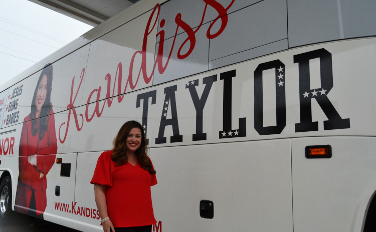 Gubernatorial candidate Kandiss Taylor stands outside her campaign bus at Hartwell Ingles.