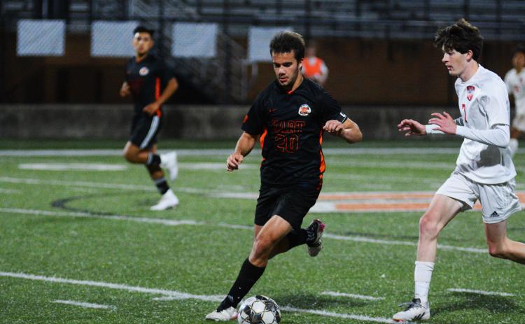Senior Aidan Gordon pushes the ball down field in his last home game as a Bulldog.