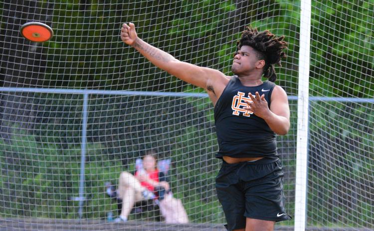 Kanye Fouch sets a school record with a 155-08 discus throw.