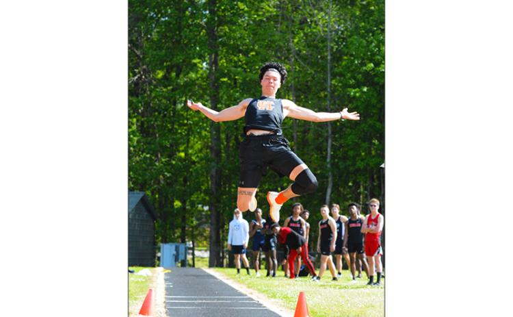 Johnny Curry flies through the air during the long jump at a home meet in Hart County earlier this season. Curry qualified for state championships in long jump, high jump and triple jump.