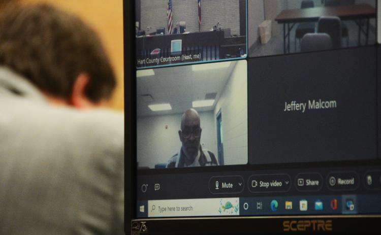Norwood, seen above, attending his hearing virtually.