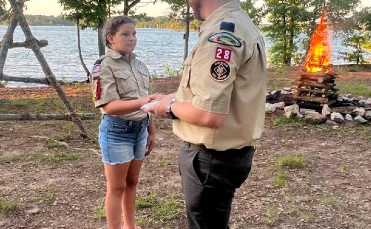 Evie McCurley, with her dad Josh McCurley, at the Scouts’ graduation ceremony.