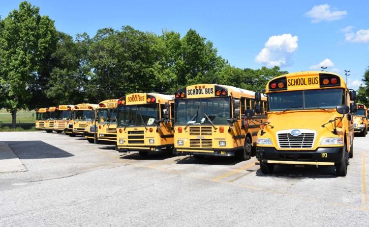 Dawson Baker/The Hartwell Sun - A row of buses sits idle adjacent to Hart County High School. School officials say the school district was spending as much $9,200 on gas per week by the end of the school year.