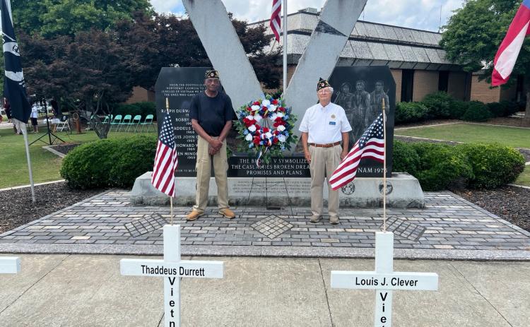 Josh Brannen/The Hartwell Sun - Vietnam veterans Thomas Morrison, left, and Bruce Jones, right, place the Memorial Day wreath at Veterans Memorial Park to honor Hart County men who sacrificed themselves in combat.