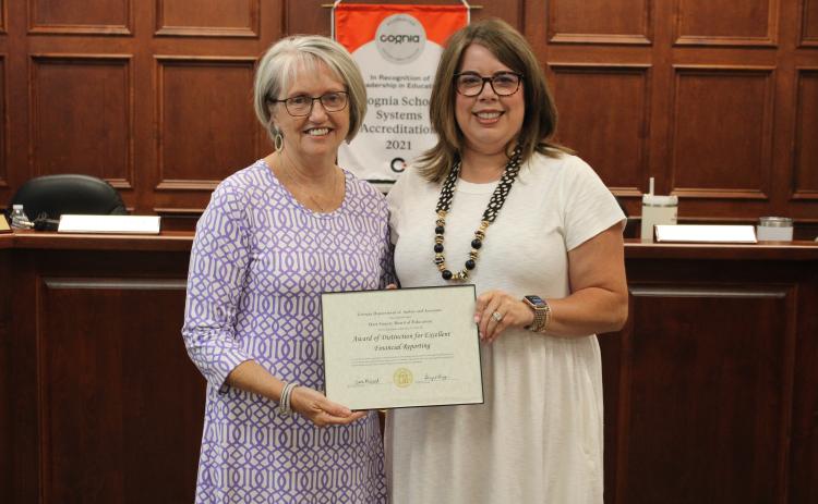 Finance director Donna Jones, left, was among those recognized for excellence in financial reporting. Board Chair Kim Pierce is pictured right.