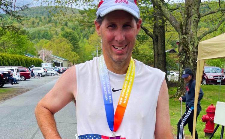 A proud Dr. Wade Walker grins after completing his mission of 50 marathons in 50 states. Walker finished his quest in Vermont on May 15.