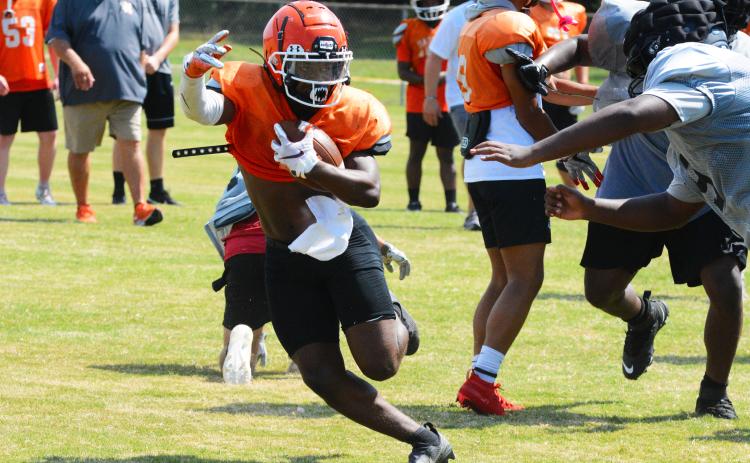 Running back Nori Moore makes a cut away from a Morgan County defender
