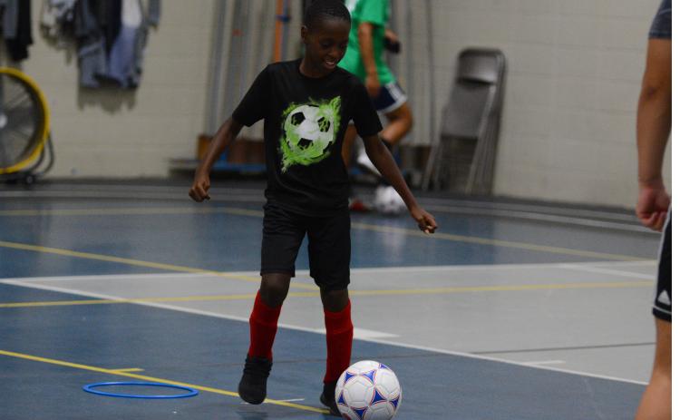 Kingston Durham practices his ball handling skills in the YMCA gym.