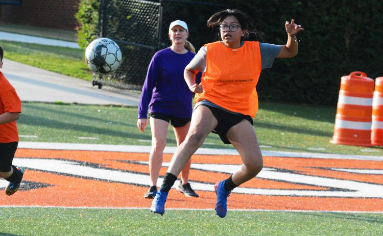 Kami Martinez hits a volley to score a goal.