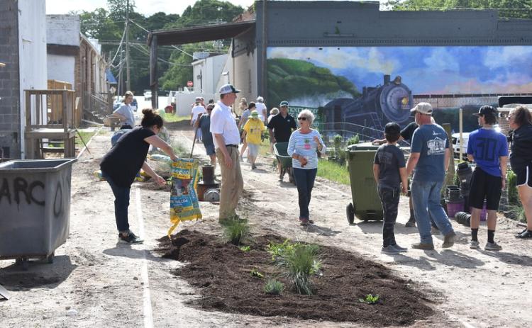 Residents turned out to help install plants in a new garden, part of a downtown streetscape in Hartwell, designed by UGA engineering students.