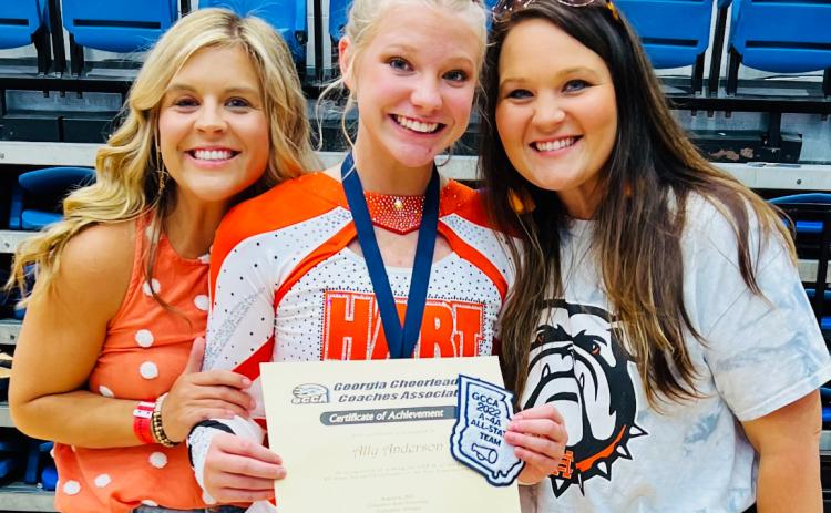 Ally Anderson (center) with her coaches Mollie Payne (left) and Ashley Risner (right) at the competition in Columbus on Saturday, Aug. 6.