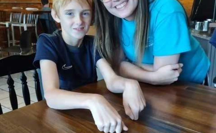 Kaden Phillips and volunteer Gracie Howington hang out at Center Field in downtown Royston.