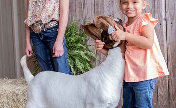 Kylie Ruff (10), Emerson Cabe (4) with Peppa Pig, the goat.