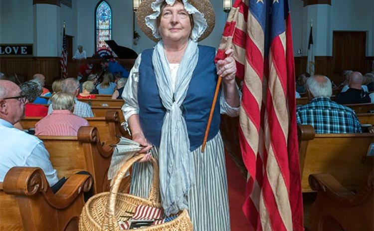 Sara Lesseur dons her Nancy Hart attire at the annual 4th of July service at Hartwell First United Methodist Church last month.