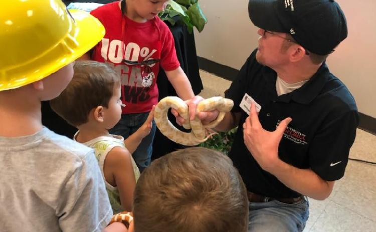 Dr. Nick Furhman shows off Snowy the corn snake to specators at the Northeast Georgia Ag Expo.