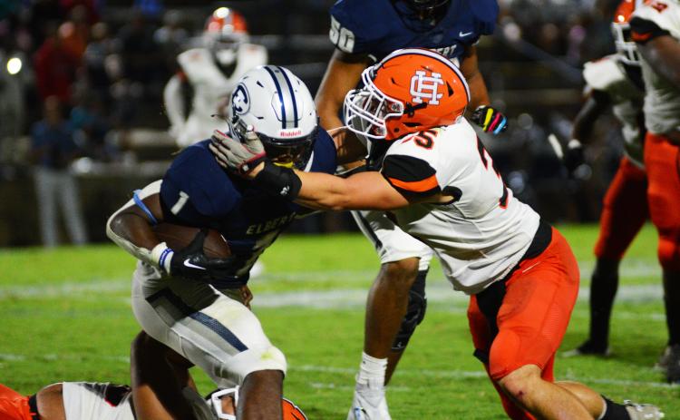 Cyrus Bowen wraps up the Elbert County running back in the backfield on Aug. 19.