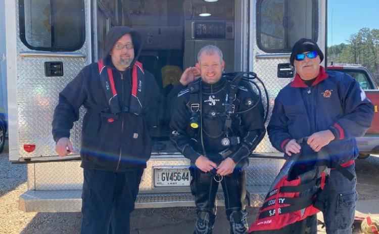Kinsey Craft (center) poses for a picture fresh from a diving exercise alongside his fellow firefighters Jason Hawley (left) and James David (right).