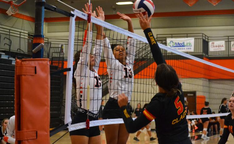 Ryleigh Jordan (left) and Alexis Walker (right) attempt a block against Cedar Shoals on Sept. 15.