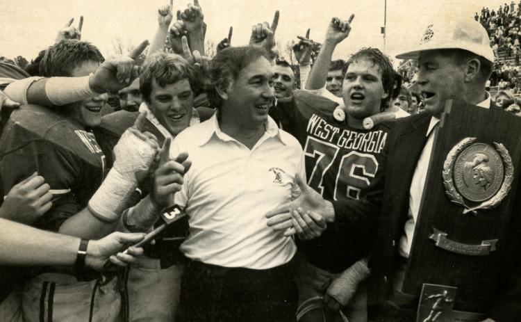 Bobby Pate receives the national championship trophy with his players in 1982.