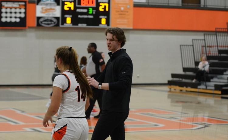 Pictured right, Ben Edwards coaches up junior guard Dakota Phillips in the Madison County win on Nov. 10.