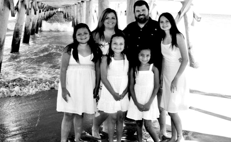 Parents Dustin and Ashley Carruth with their adopted kids (L-R) Sellie, Harper, Evie Rae and Jaydyn,