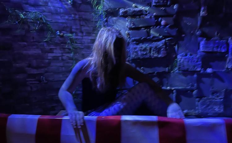A wretched soul begs for help to escape her dark imprisonment at the community theater.