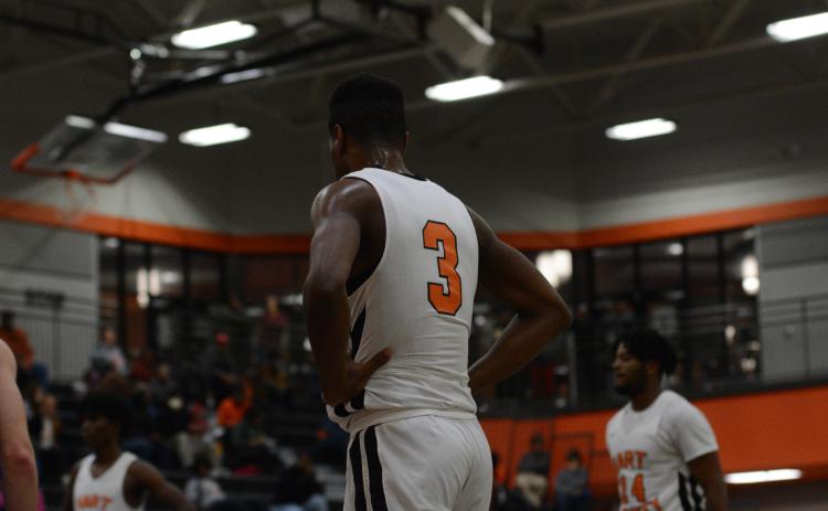 Tahj Johnson stands in along the lane during a free throw.