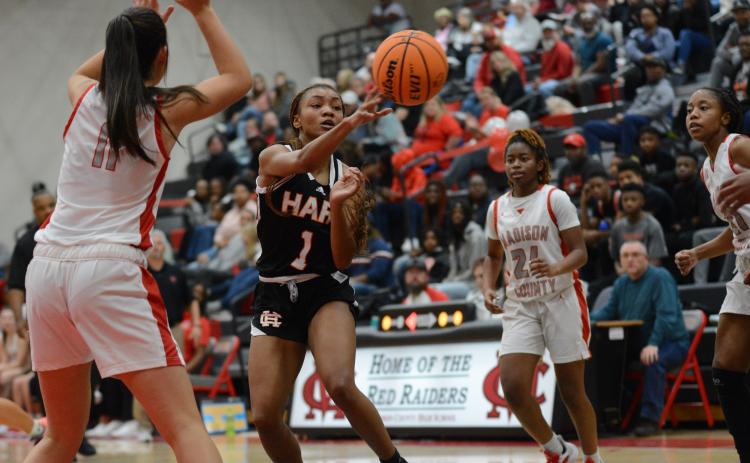 Senior guard Valasha Carter dishes it to an open teammate in the Lady Dogs close win at Madison County on Dec. 10.