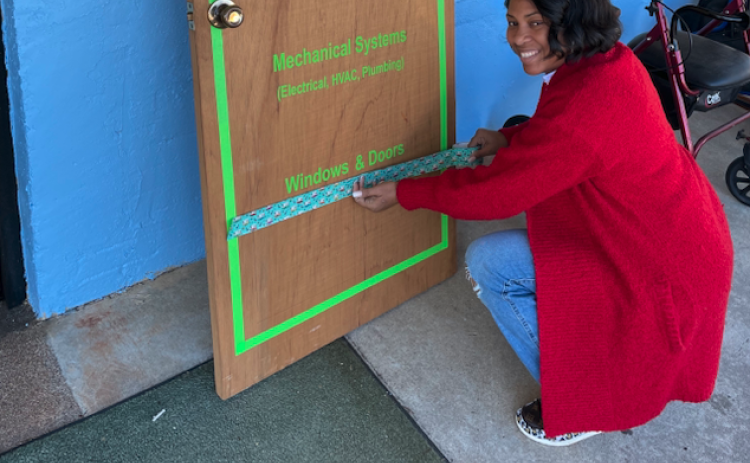 Shamrika Johnson crossing out her first tier at the Hart County Habitat for Humanity Restore headquarters at 900 Benson Street.