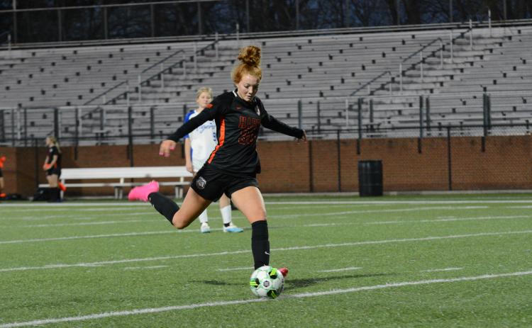 Pictured is sophomore forward Channing Segars scoring one of her three goals in the 8-1 win over Washington-Wilkes on March 10.
